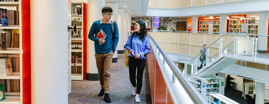 students walking together in library